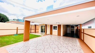 Spacious patio area with tiled flooring and landscaped lawn