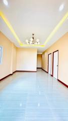Spacious and brightly lit empty interior room with glossy tiled flooring and LED lighting