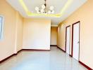 Spacious and brightly lit empty interior room with glossy tiled flooring and LED lighting