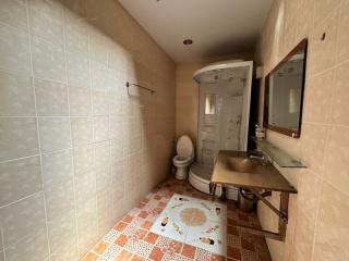 Modern bathroom with beige tiles and shower cabin