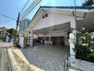 Spacious covered driveway leading to the entrance of a residential home