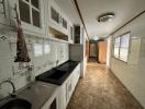 Spacious kitchen with ample cabinet space and tiled backsplash