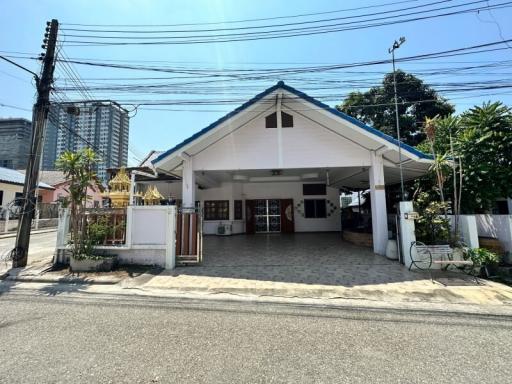 Spacious residential building with large front yard and open carport