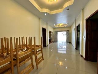 Spacious dining room with large table and tiled flooring