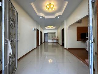 Spacious hallway with chandelier and tiled flooring