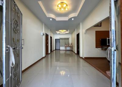 Spacious hallway with chandelier and tiled flooring