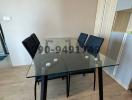 Modern dining area with glass table and chairs