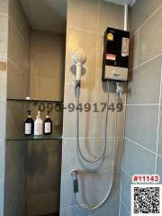 Modern bathroom with wall-mounted water heater and handheld shower