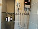 Modern bathroom with wall-mounted water heater and handheld shower