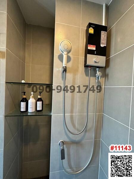 Modern bathroom with wall-mounted water heater and handheld shower