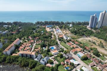 Aerial view of a coastal residential area with various properties