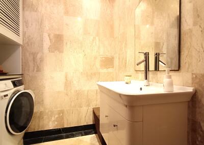 Modern bathroom with marble walls and porcelain sink