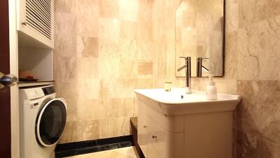 Modern bathroom with marble walls and porcelain sink