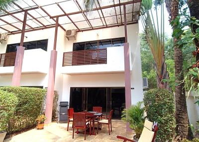 Spacious patio area with outdoor seating and lush greenery