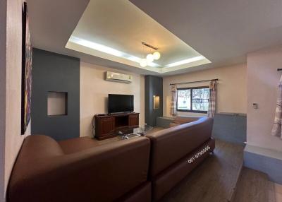 Spacious living room with modern lighting and comfortable seating