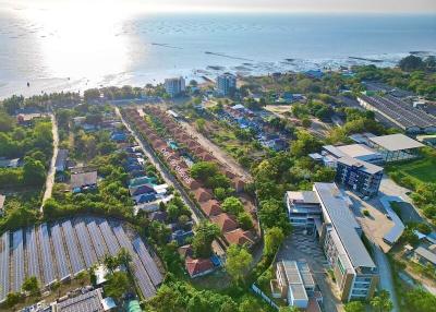 Aerial view of coastal residential area with various buildings