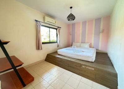 Spacious Bedroom with Striped Pink Wall and Window