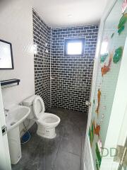 Modern bathroom interior with tiled walls and glass shower cabin