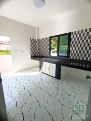 Modern kitchen with checkered backsplash and unique tiled flooring