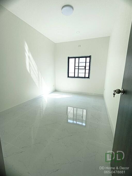 Bright empty room with large window and glossy tiled flooring
