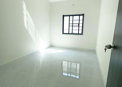 Bright empty room with large window and glossy tiled flooring