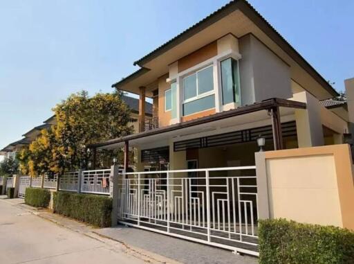 Modern two-story house with spacious balcony and gated entrance