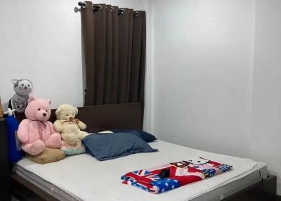 Cozy bedroom with large bed and plush toys