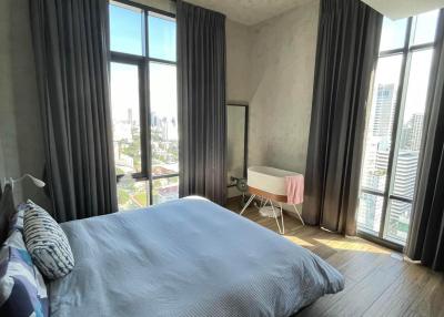 Modern bedroom with natural light and city view