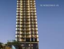 Exterior view of The Lofts Asoke high-rise residential building at dusk