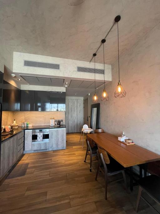 Modern kitchen with wooden details and pendant lighting