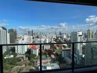 Panoramic cityscape view from high-rise apartment balcony