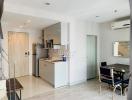 Modern open-concept kitchen with adjacent dining space in a bright apartment