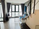 Modern bedroom with large window and staircase leading to an upper level in an urban apartment