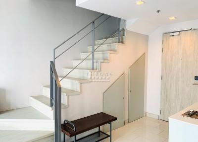 Modern staircase in a building entrance with bench and clean design
