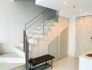 Modern staircase in a building entrance with bench and clean design