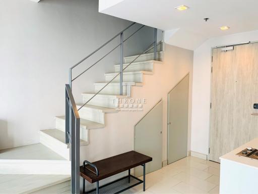Modern staircase in a building entrance with bench and clean design