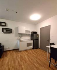 Compact kitchen with modern appliances and wooden flooring