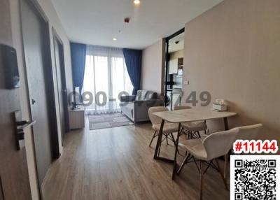 Spacious and modern living room with dining area and adjoining balcony