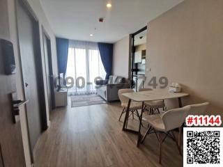 Spacious and modern living room with dining area and adjoining balcony