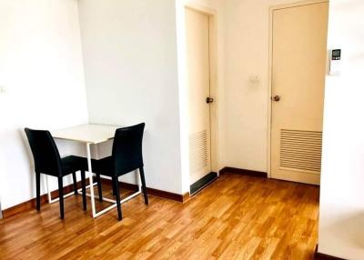 Bright dining area with a table, chairs, and hardwood flooring