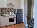 Compact kitchen with modern appliances and wood laminate flooring