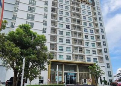 Exterior view of a modern multi-story apartment building with clear skies