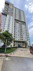 Exterior view of a modern multi-story apartment building with clear skies