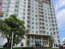 Exterior view of a modern multi-story apartment building with clear skies