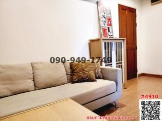 Cozy living room with a comfortable couch and wooden flooring