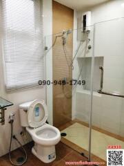 Modern bathroom with glass shower enclosure and white fixtures