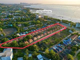 Aerial view of a residential development near the coastline with marked property boundaries