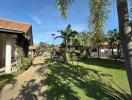 Peaceful residential community with lush green lawns and tropical palm trees