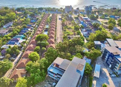 Aerial view of a residential area with streets and houses near the coastline