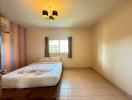 Spacious Bedroom with Large Window and Striped Wall